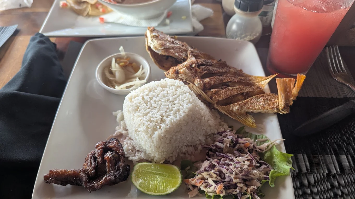 Whole fried fish with rice and coleslaw