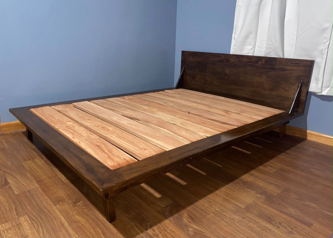 Custom hardwood bed frame in a finished room